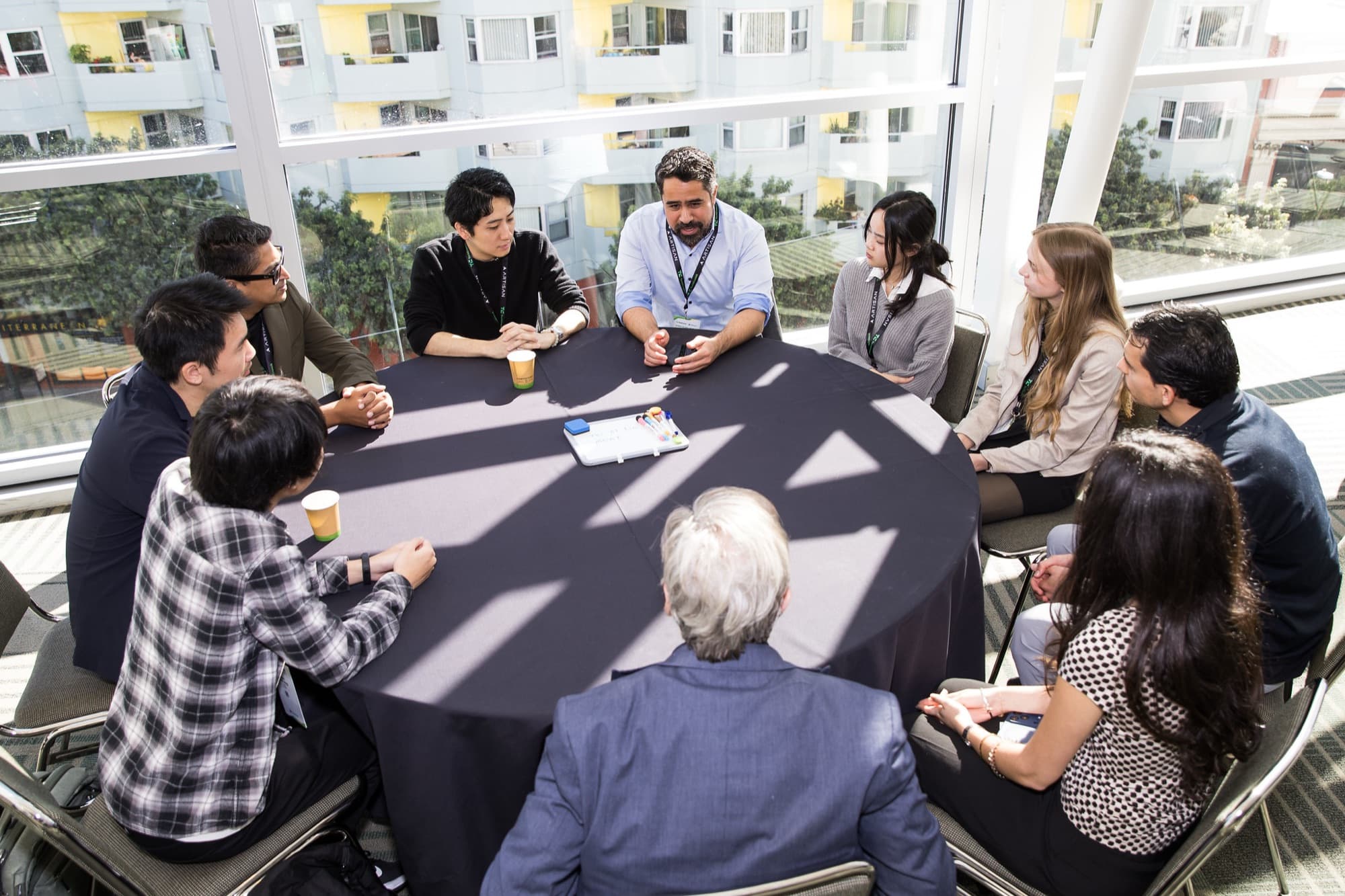 A small group in conversation around a table at TechCrunch Disrupt